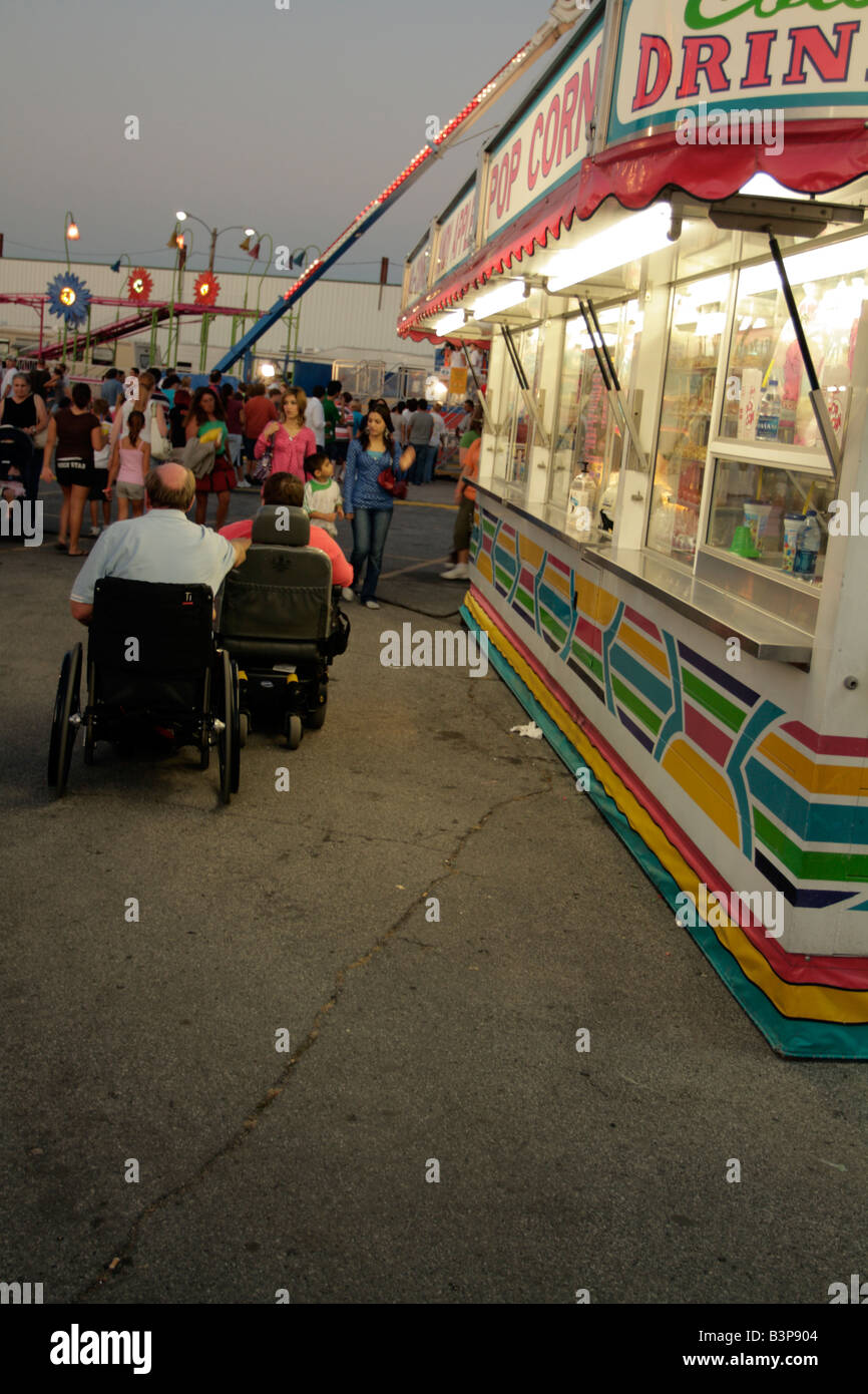 Cruising the midway, a male and female companions in wheelchairs Stock Photo Alamy