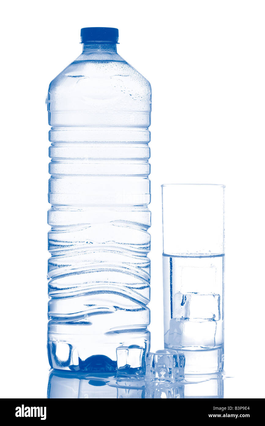 Bottle and glass of mineral water with ice cubes reflected on white ...