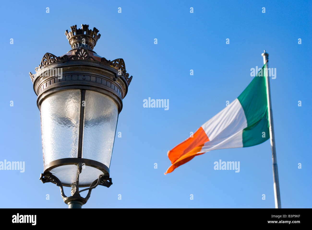 Decorative traditional street lamp and irish flag flapping in the wind