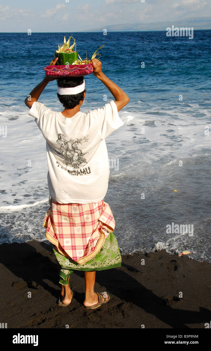 man at beach , praying, cremation ritual , bali , republic of indonesia ...