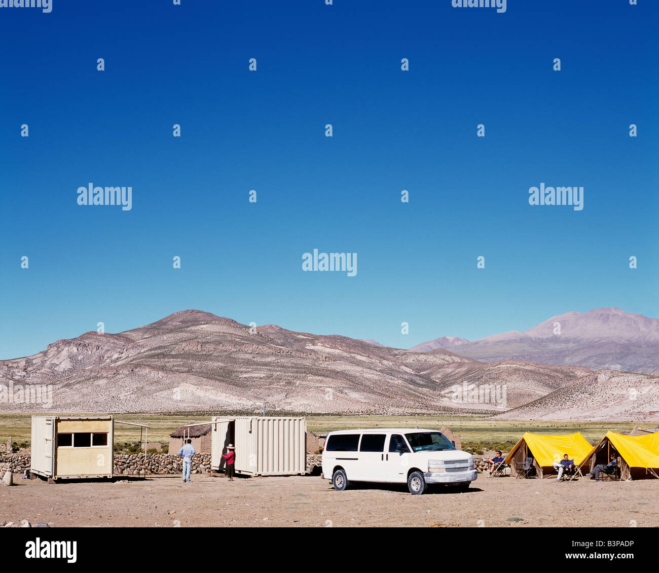 Chile, Parque Nacional Volcan Isluga. Camping in style. At Explora's Camp in Parque Nacional Volcan Isluga two shipping containers have been converted, one into a kitchen and dining room and the other into a bathroom block to be provide comfort in the wilderness. Stock Photo