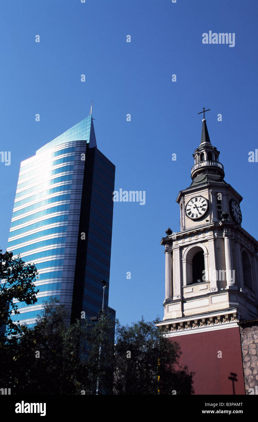 Chile, Santiago. Rising either side of Avenida del Libertador Bernardo O'Higgins, Santiago's main east-west throughfare, colloquially known as La Alameda, are the two faces of Santiago. On the left a modern high-rise office building and on the right the tower of Iglesia San Francisco, Santiago's oldest building (built in 1586-1628AD) Stock Photo