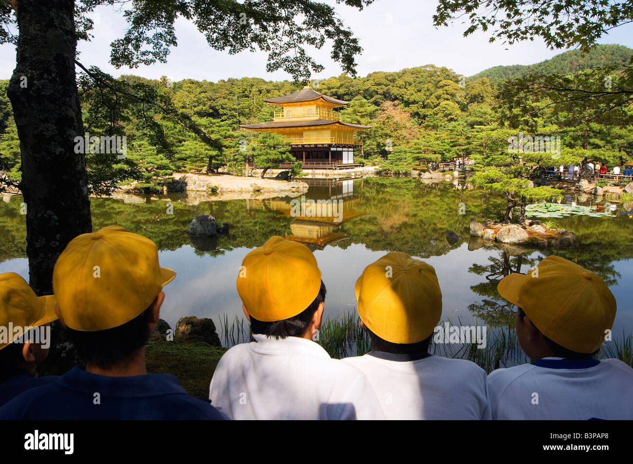 Japan, Honshu, Kyoto . Kinkakuji, Golden Pavillion Temple school children with yellow hats Stock Photo