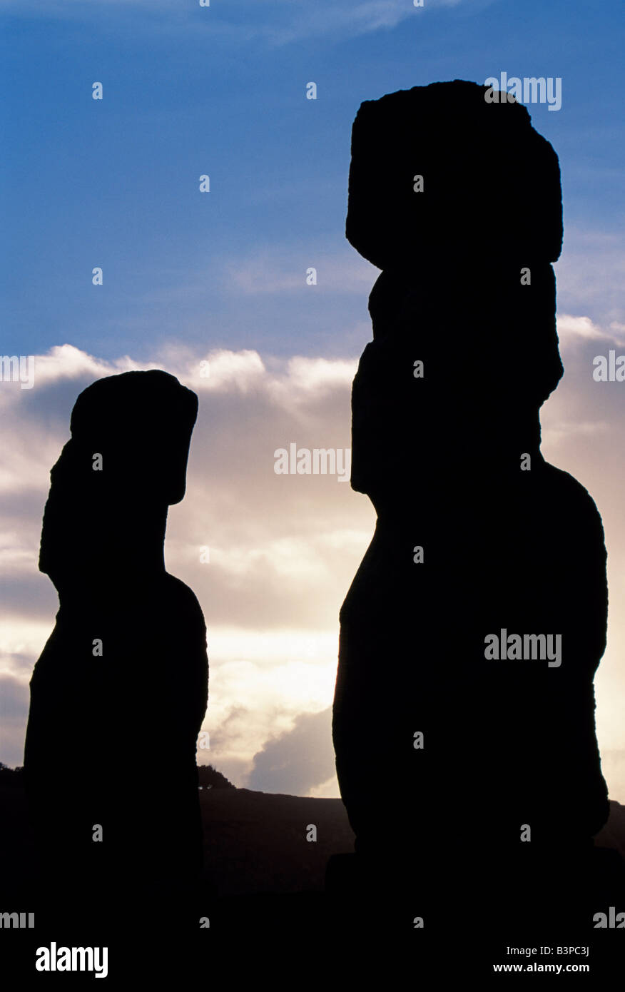 Chile, Easter Island, Tongariki. Two of the fifteen colossal stone statues or moais of Tongariki at sunrise. Stock Photo