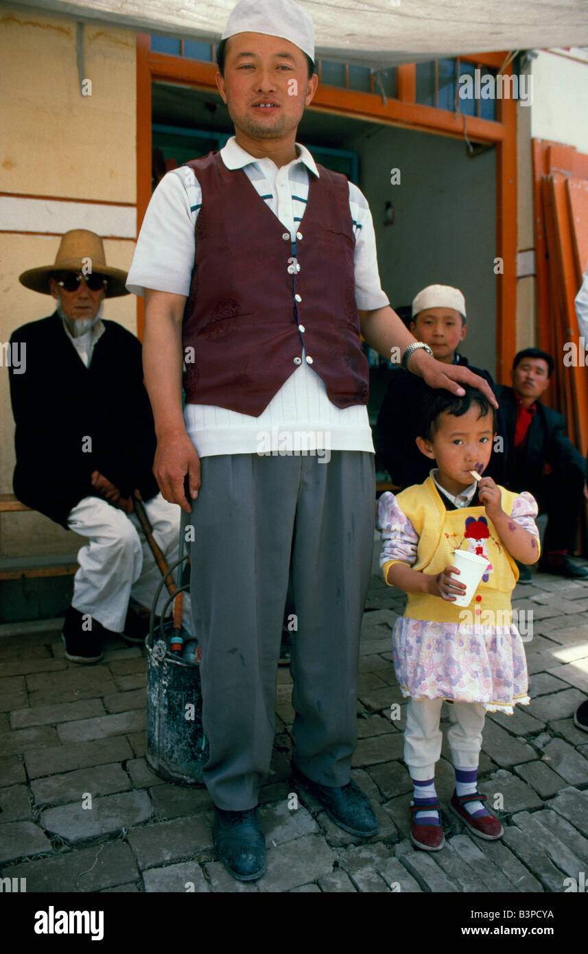 China, Gansu Province, Linxia. A Hui family outside their shop. The Hui are China's only so-called 'minority nationality' Stock Photo