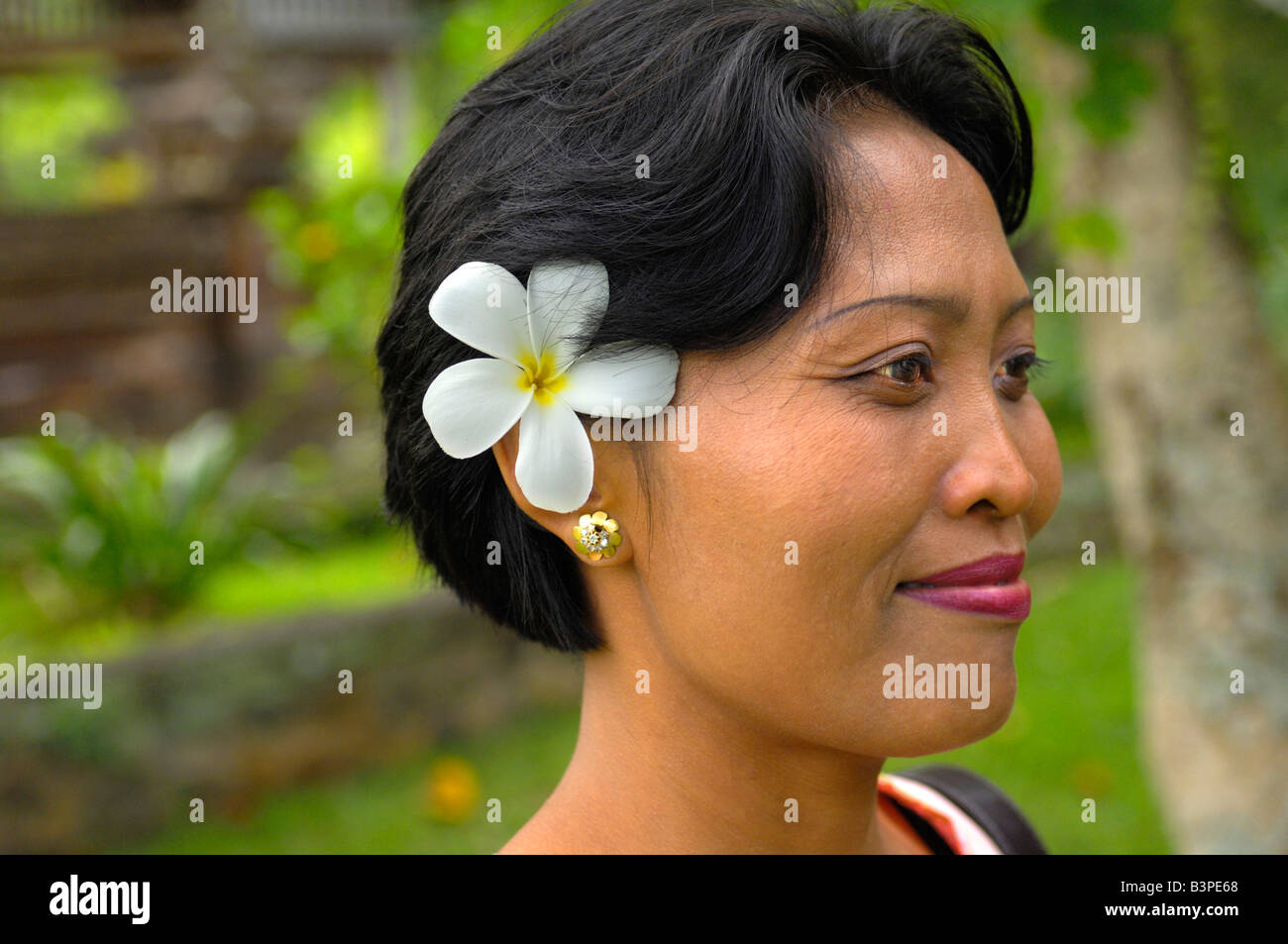 Balinese woman wearing Frangipani (Plumeria) in her hair, Bali
