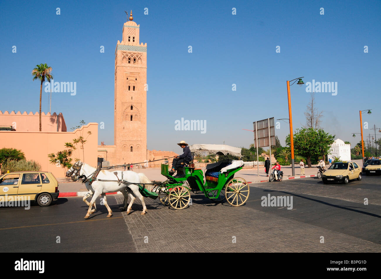 Horse drawn carriage in front of the Koutoubiya-Mosque of 1158 with the only completed minaret of the Almohaden period, Marrake Stock Photo