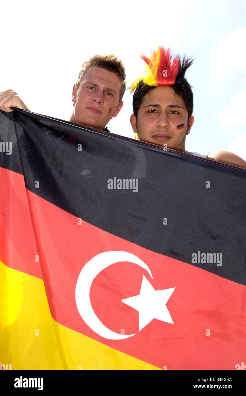 Fans of the German and Turkish national soccer teams holding a combined flag on Schlossplatz Square, Stuttgart, Baden-Wuerttemb Stock Photo