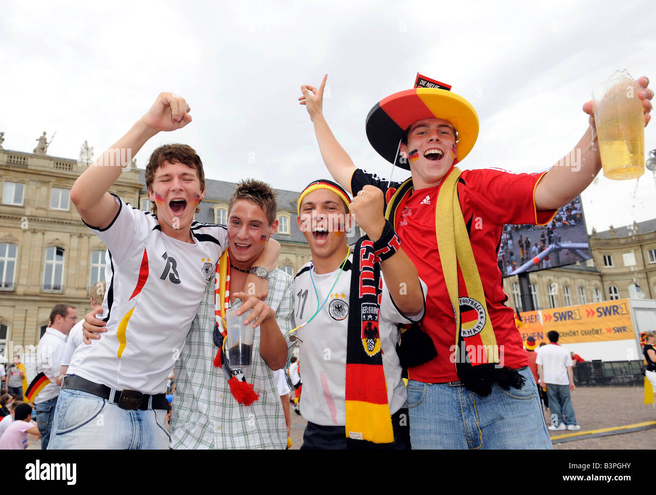 GERMANY, East Germany, Plau, floating mini football field with goal and  german flags, four paddling fans in football jersey of German women soccer  team and beer box, at funny boat contest and