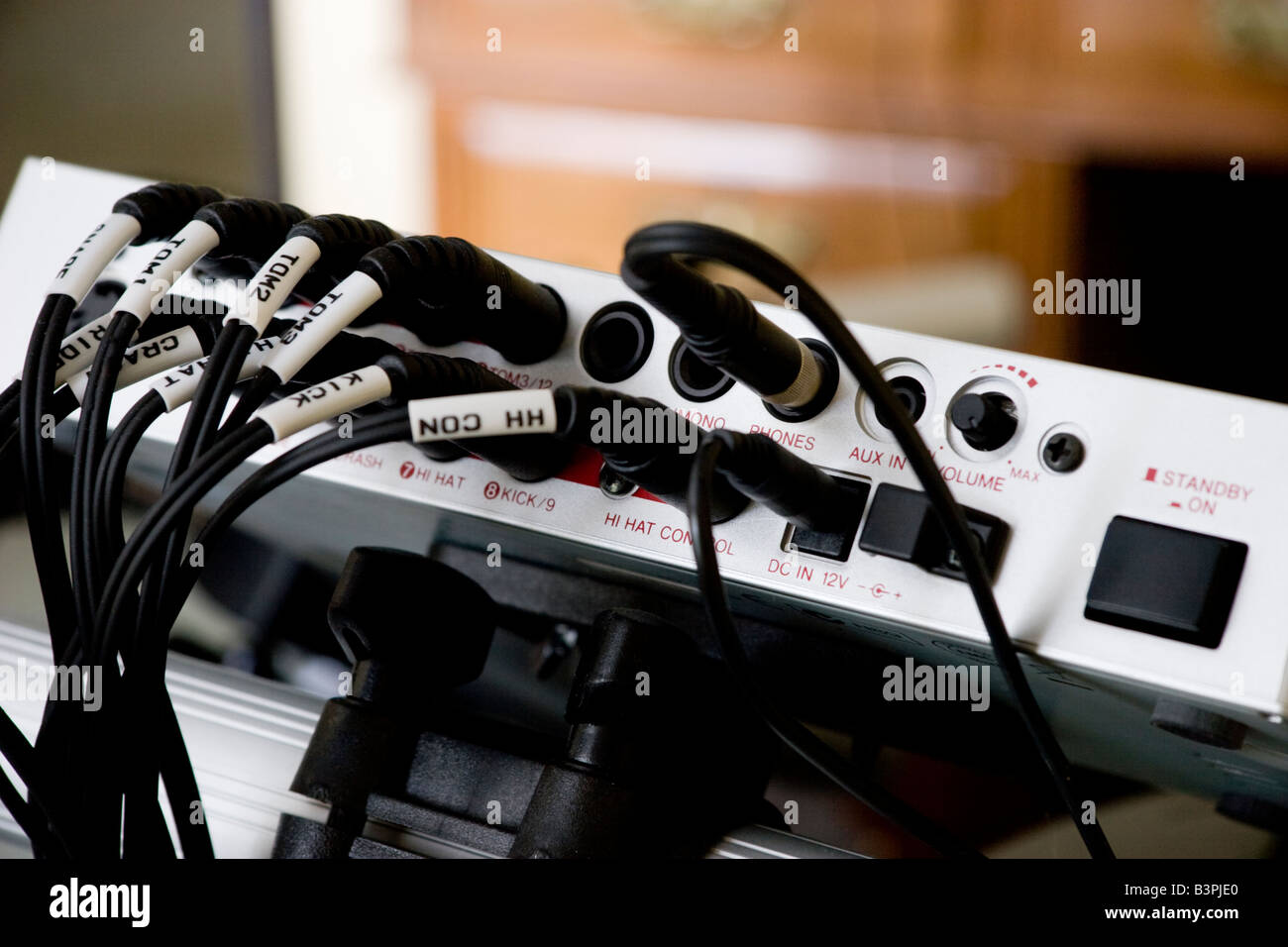 Audio jacks plugged in to the control box of an electronic drum kit