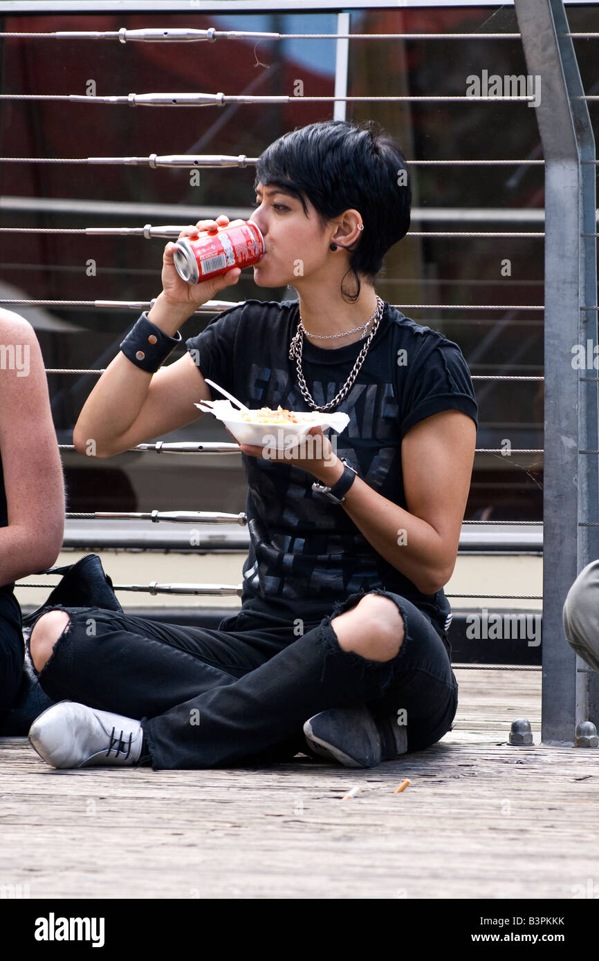 Camden Lock Market Very Pretty Female Teenager In Black With Torn Jeans Chains And Leather Wrist Band Eats Snack By Canal Stock Photo Alamy