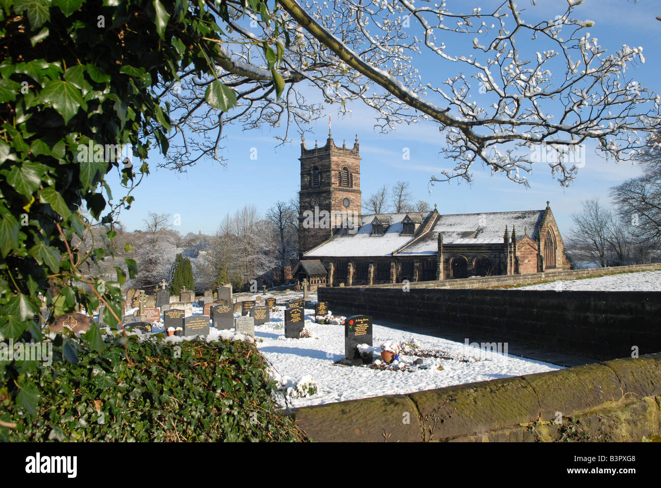 Parish Church of Saint Mary's in Rostherne village near Knutsford, Cheshire on a snowy April morning 2008 Stock Photo