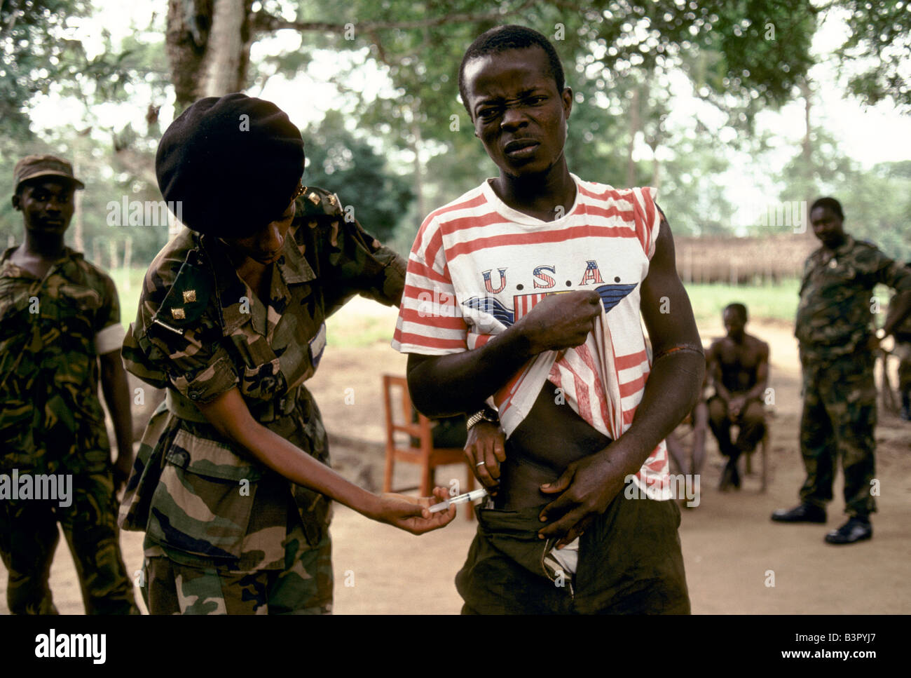 JULY 1992: A REBEL SOLDIER IS GIVEN AN INNOCULATION FOR WOUND BY GOVERNMENT SOLDIERS WHO RECENTLY CAPTURED HIS GROUP OF REBELS. Stock Photo