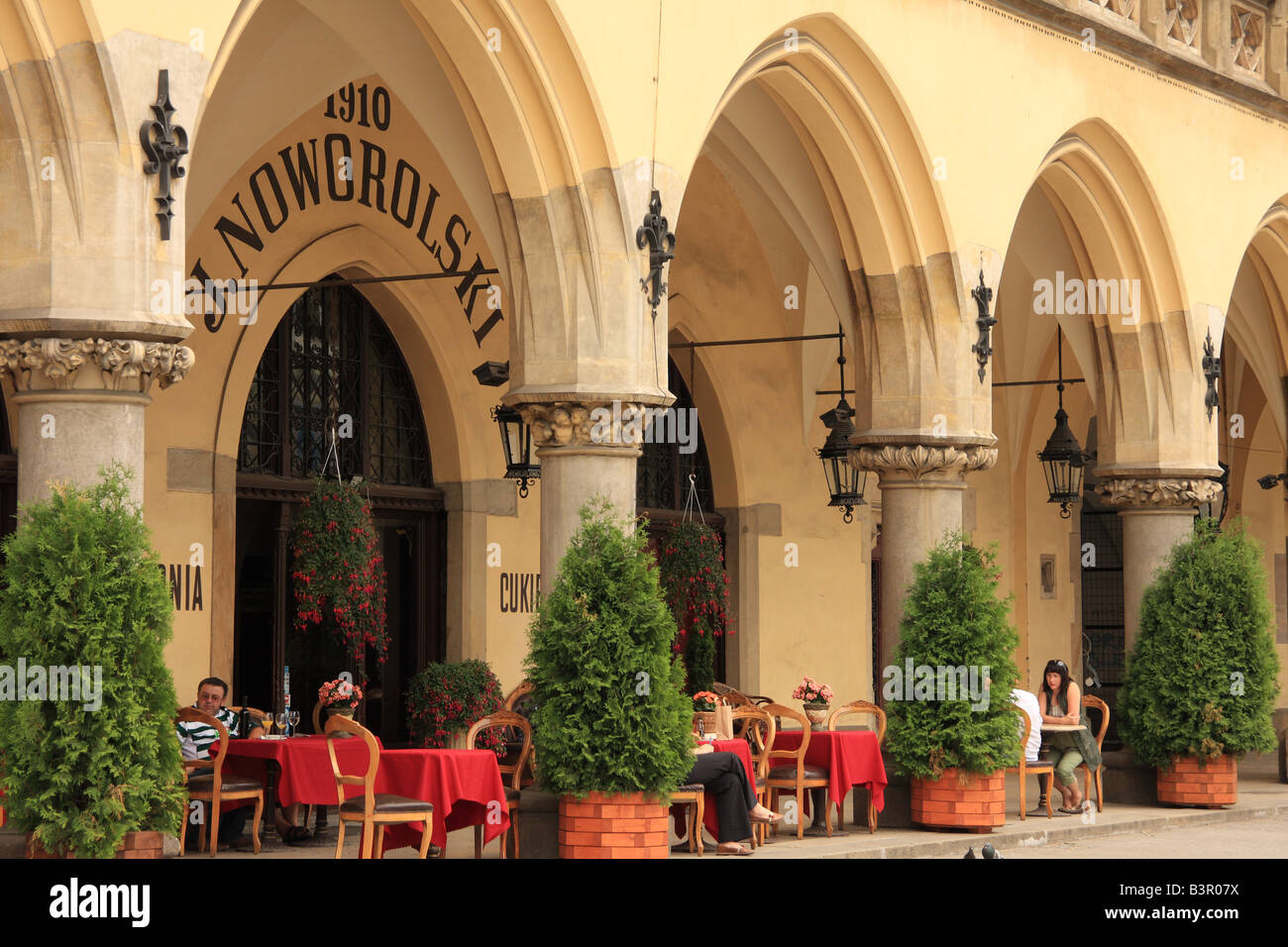 Outdoor dining area at the Cafe Noworolski, in the Sukiennice on Rynek Glowny - the huge medieval Market Square, Krakow, Poland Stock Photo