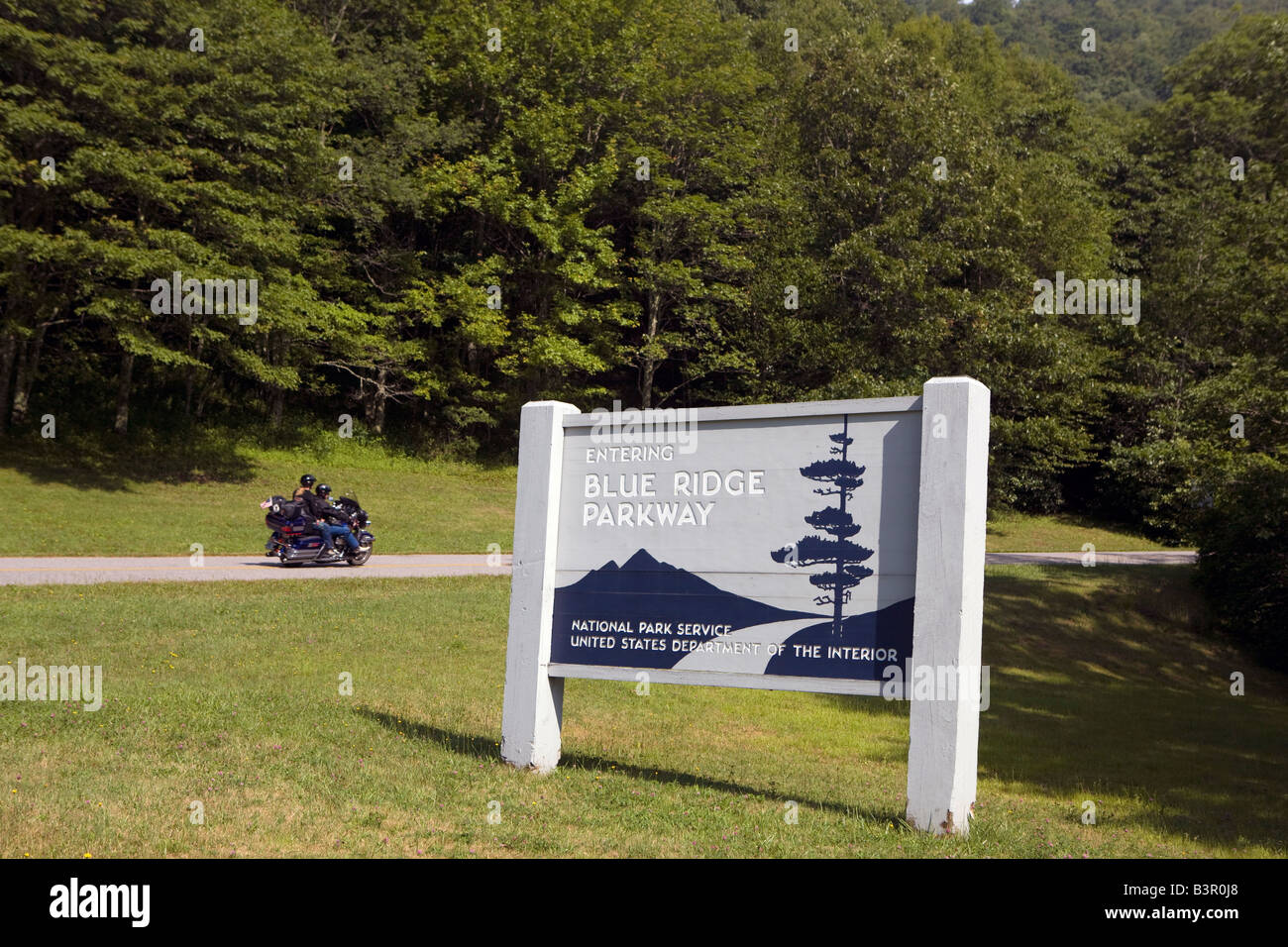 A motorcycle rides up the entrance to the Blue Ridge Parkway at US 19, Haywood and Jackson County line, North Carolina Stock Photo