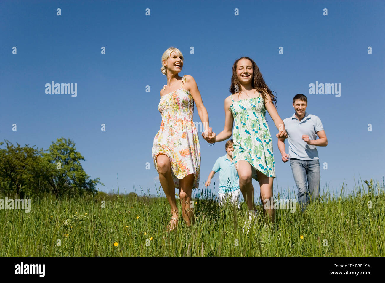 Germany, Baden Württemberg, Tübingen, Family walking through meadow Stock Photo