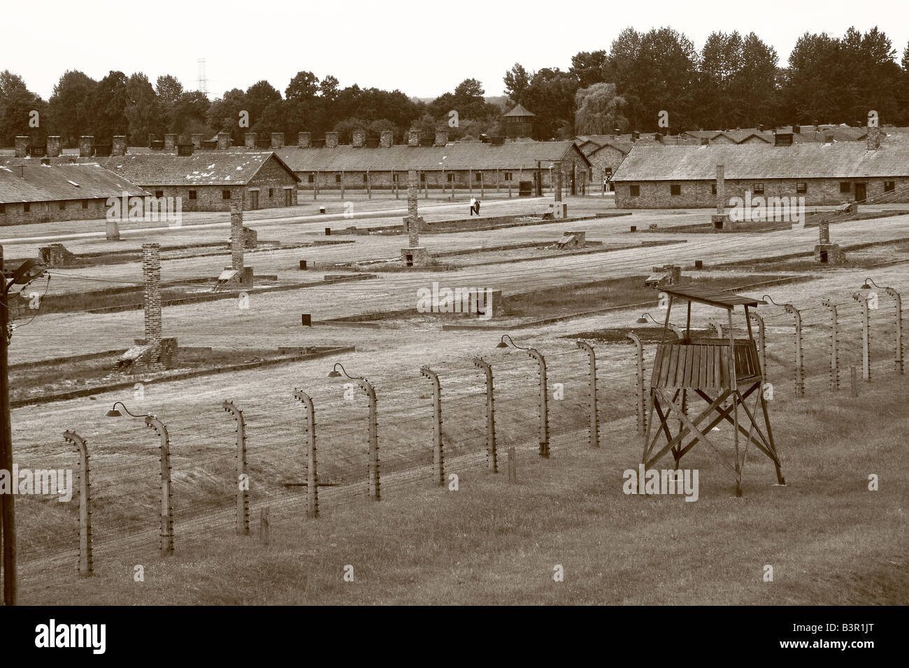 View of barracks. watchtower and fencing at Auschwitz-Birkenau concentration camp Stock Photo