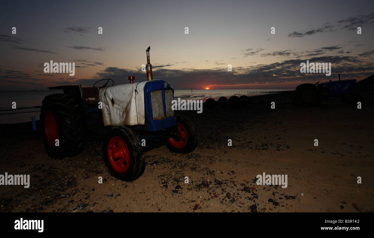 Cromer beach in the morning with fishing boat launch tractors. Stock Photo