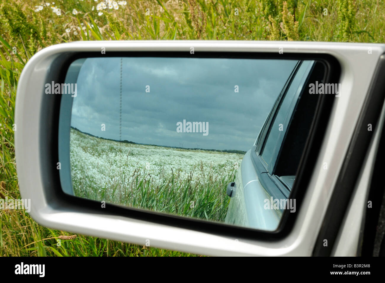 Field in the door mirror Feld im Außenspiegel Stock Photo