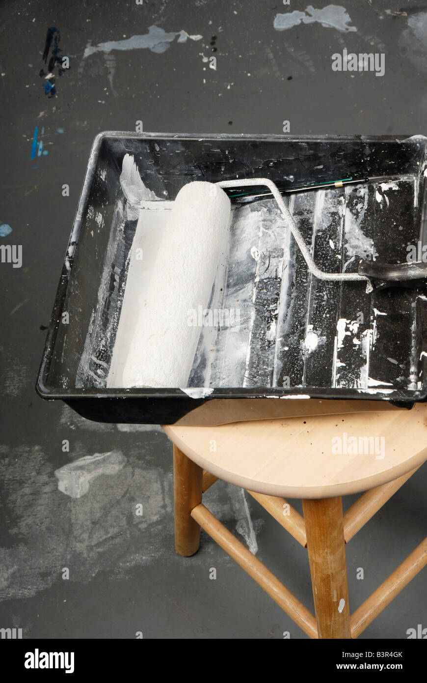 Paint pan and paint roller on stool Stock Photo Alamy