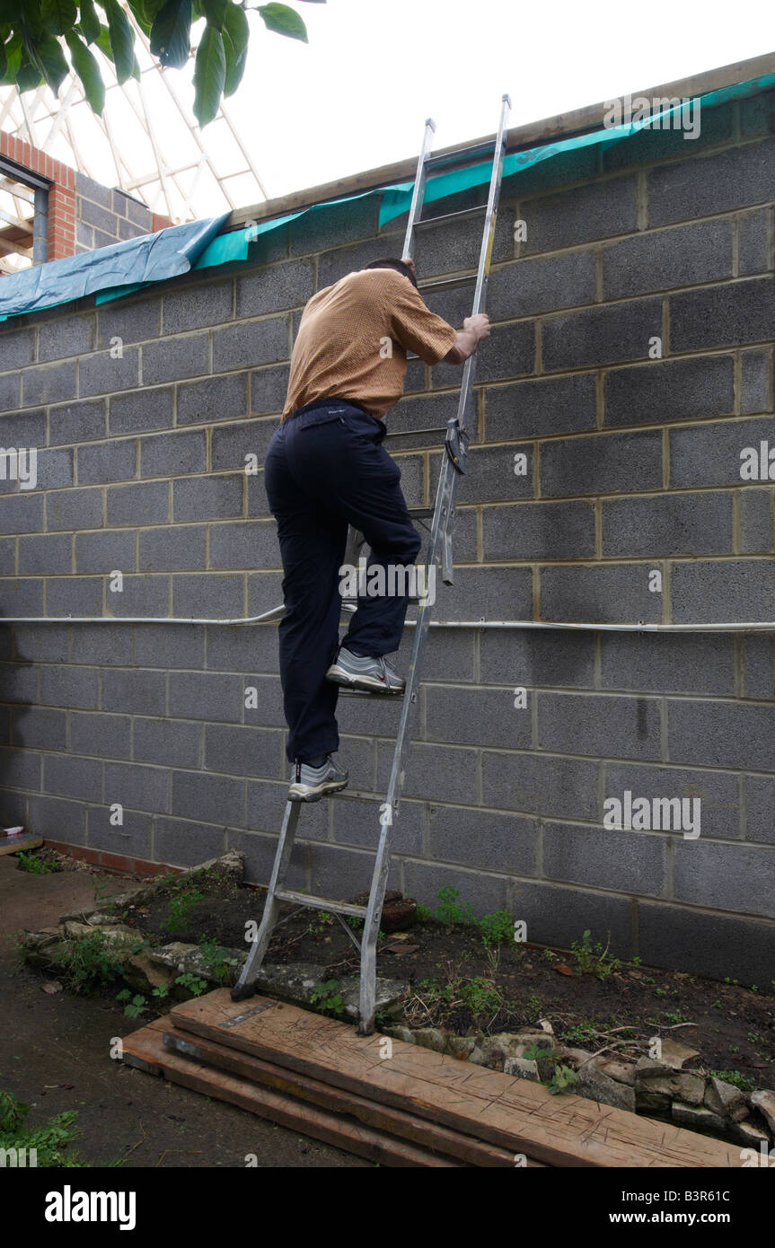 Ladder leaning against brick wall hires stock photography and images
