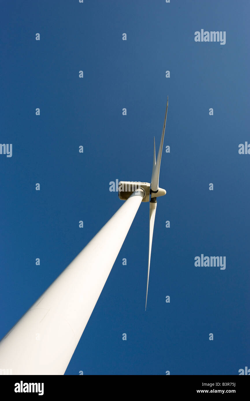 A windmill seen from below, reching up against the clear blue sky Stock Photo