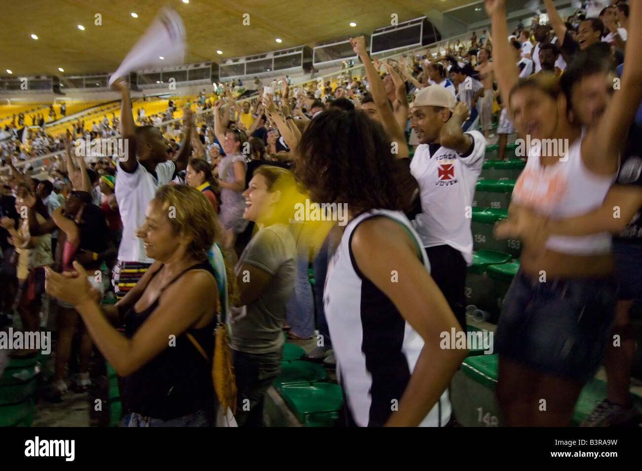 Local and tourists cheer as a goal is scored at a football match at the Maracana stadium in Rio between Vasco and Fluminense. Stock Photo