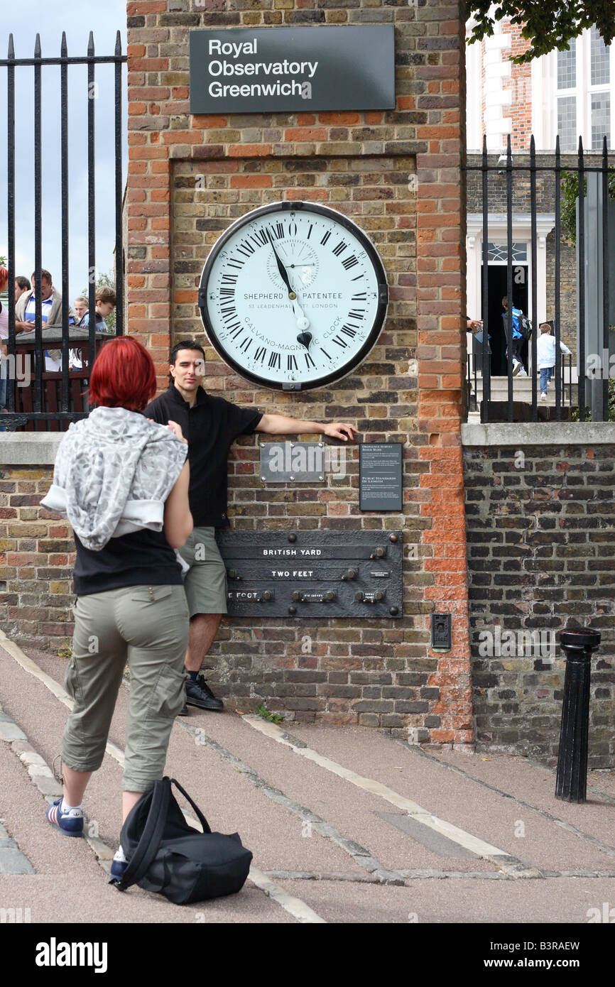 The Royal Observatory at Greenwich London tourist visitors pose by the time  clock and British Standard measurements Stock Photo - Alamy