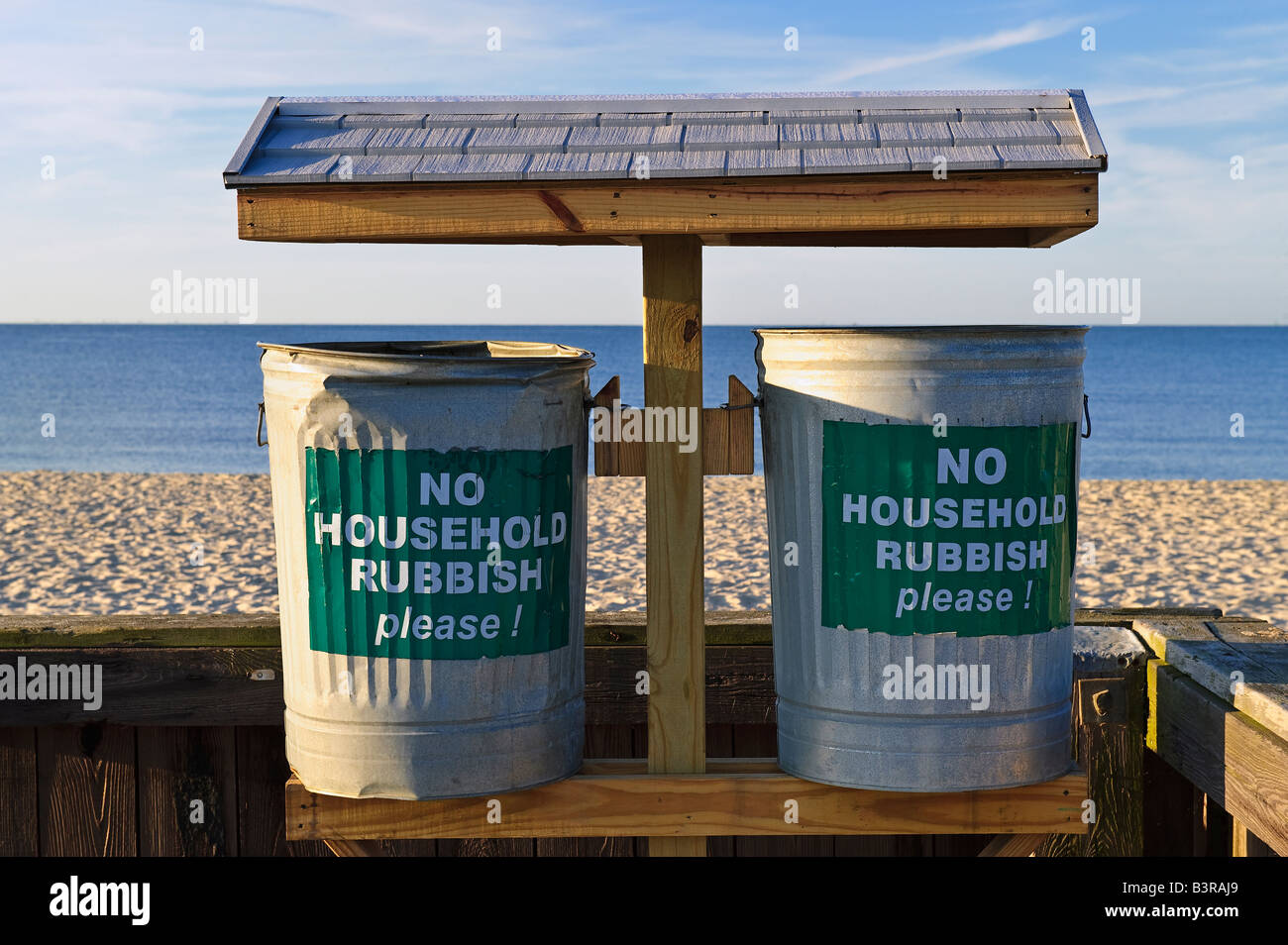Trash cans placed along the beach to discourage littering as well as dumping Cape Cod MA USA Stock Photo
