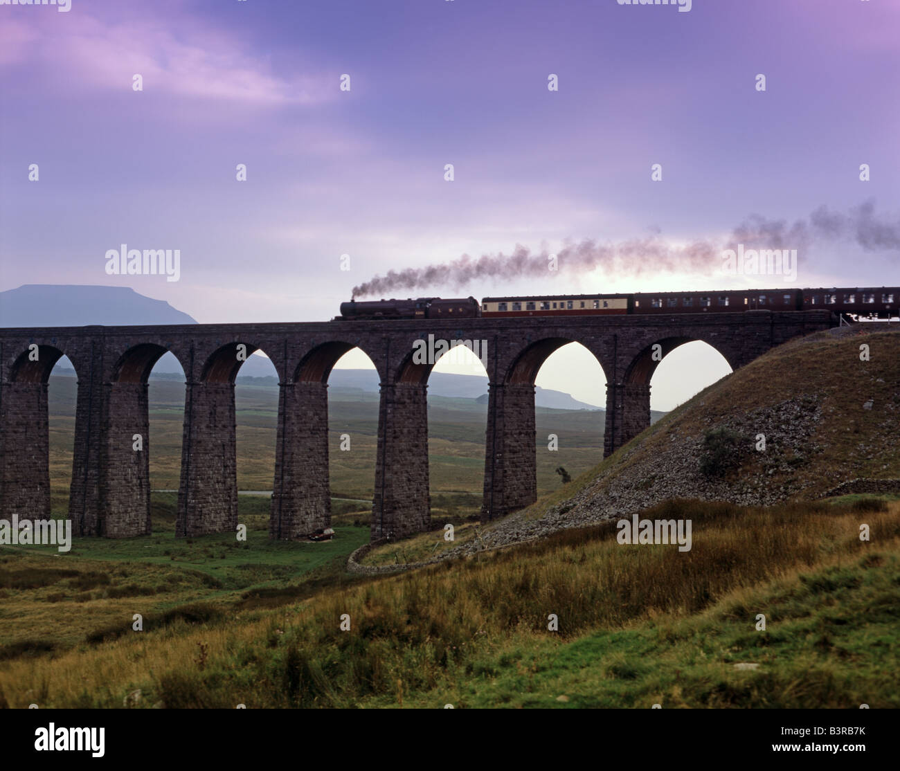 Steam train crosses Ribblehead Viaduct railway North Yorkshire dales Stock Photo