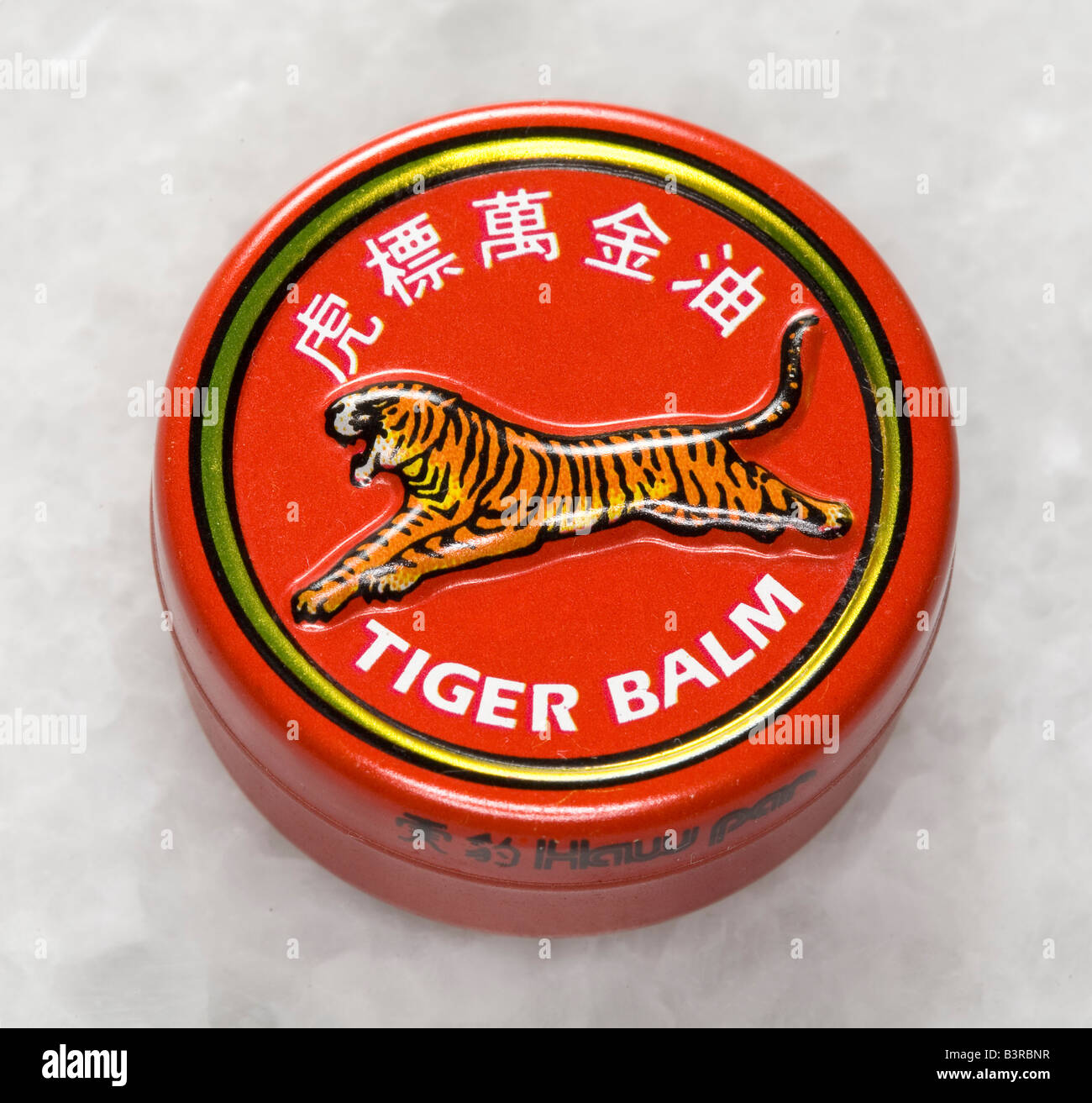 Small tin of Tiger balm famous medicinal rub for aches and pains. Stock Photo