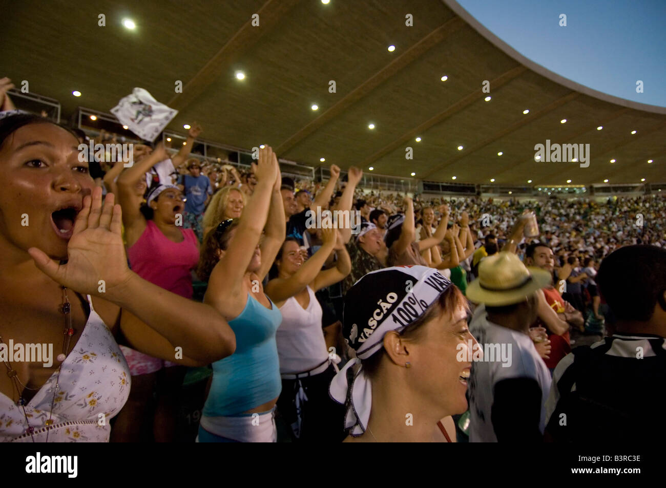 Local and tourists cheer as a goal is scored at a football match at the Maracana stadium in Rio between Vasco and Fluminense. Stock Photo