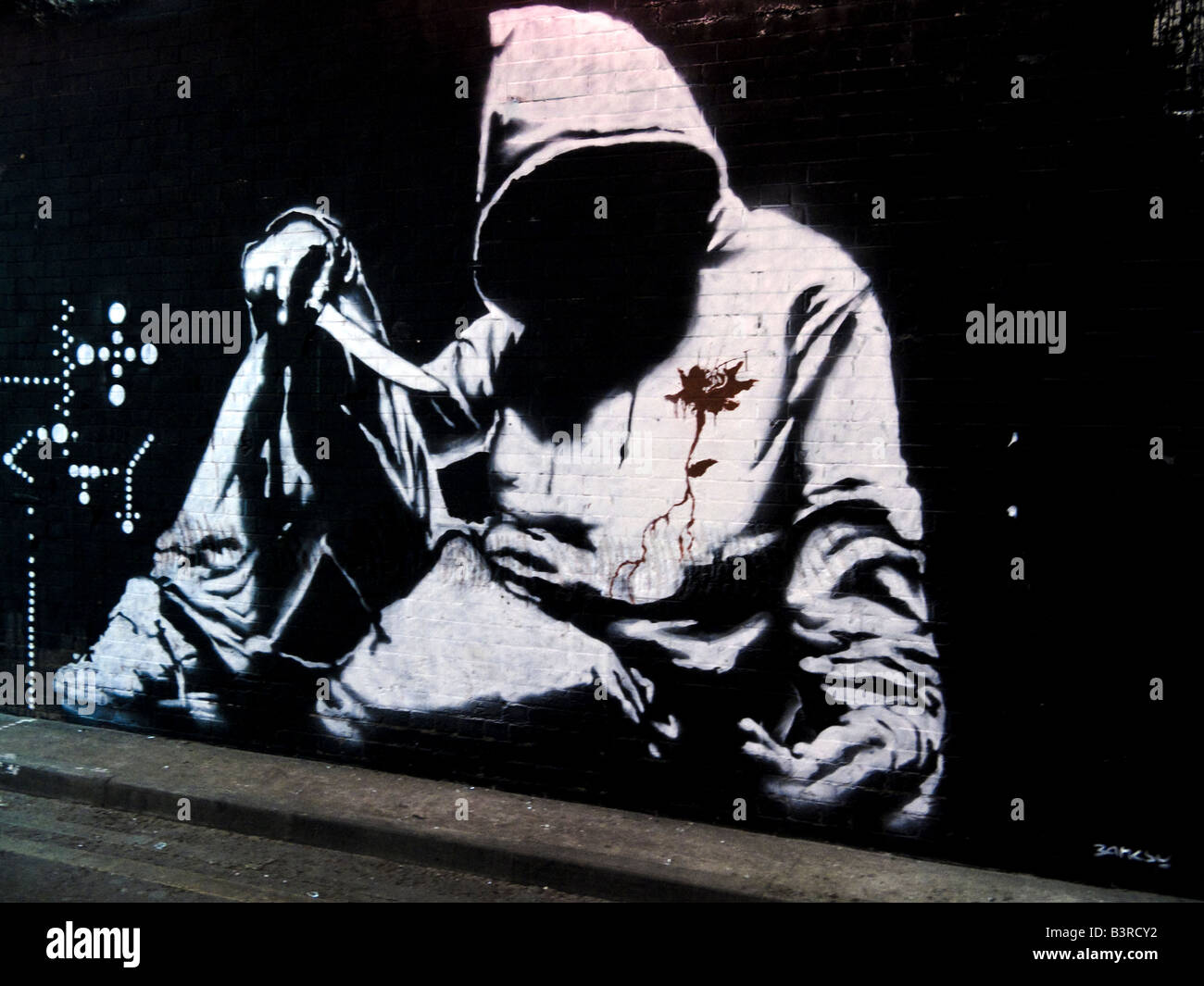 Banksy graffiti Hoodie with knife Leake Street Waterloo London, Cans Festival. Banksy graffiti Stock Photo