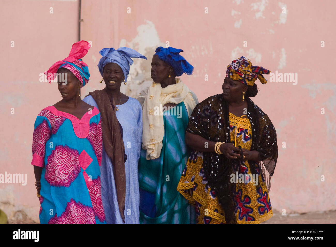 Women in traditional West African costumes on their way to mosque ...