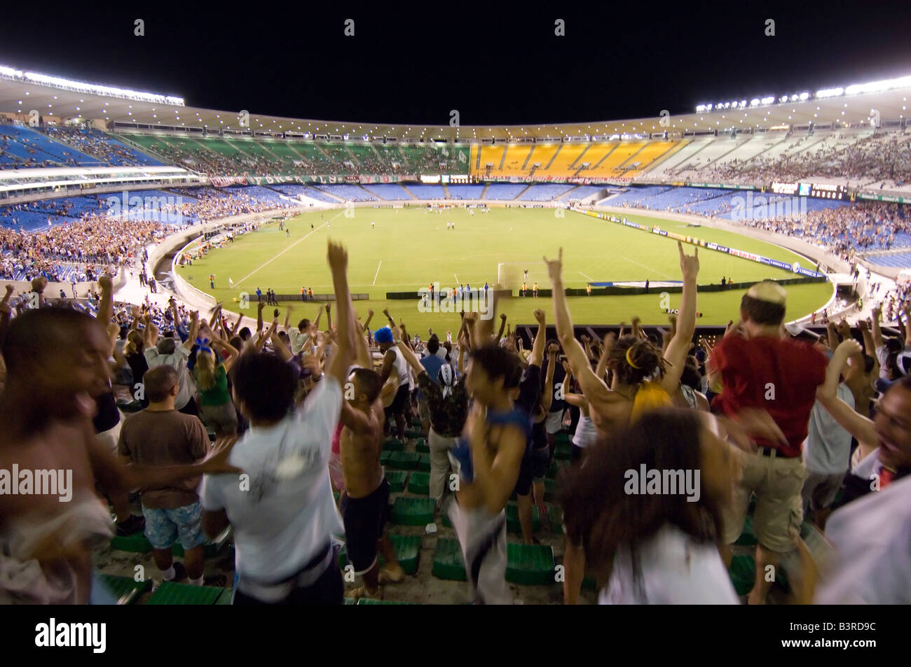 Local Brazilians cheer as a goal is scored at a football match at the Maracana stadium in Rio between Vasco and Fluminense. Stock Photo