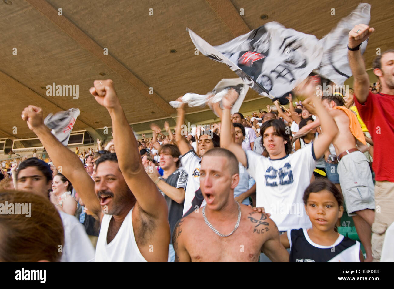 Local Brazilians cheer as a goal is scored at a football match at the Maracana stadium in Rio between Vasco and Fluminense. Stock Photo