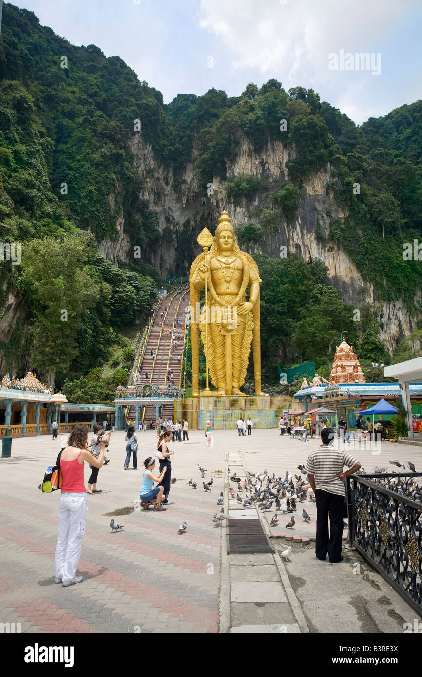 Batu caves Malaysia (around 400 million years old.) with the recent addition of the Murukan gold coloured statue Stock Photo