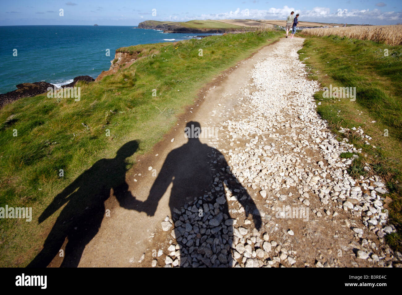 Family on cliff top walk near Trevone in Cornwall UK Stock Photo