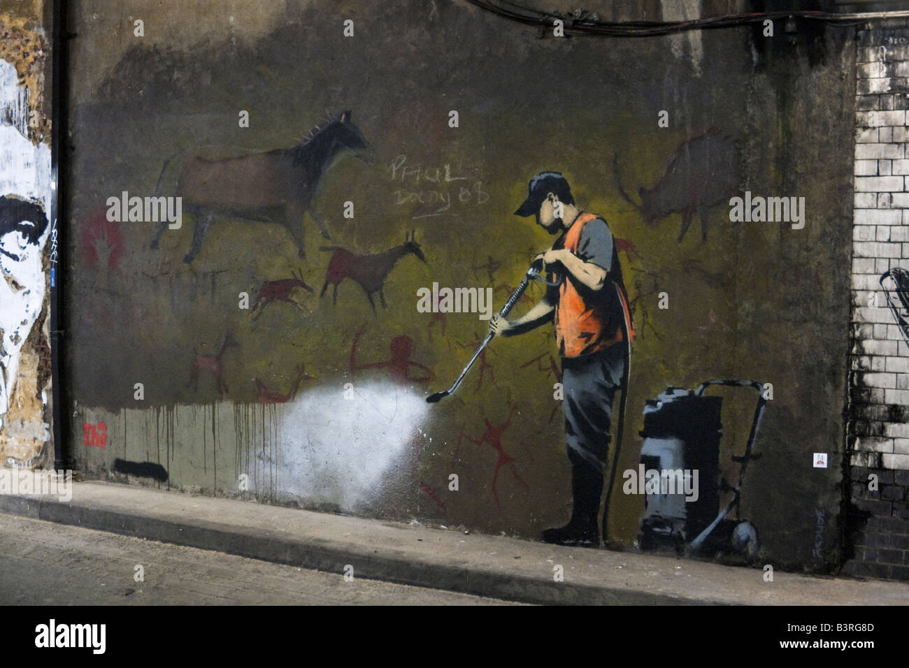 Banksy graffiti Cave Painting Removal Leake Street Waterloo London Cans Festival. Banksy graffiti Stock Photo