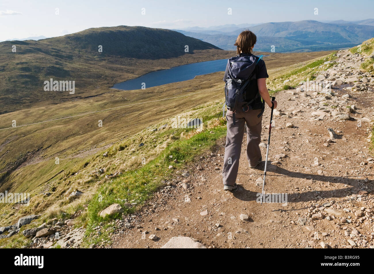 Single female hiker hikes normal route trail towards summit of Ben Nevis, Britain's highest mountain, Lochaber, Scotland Stock Photo