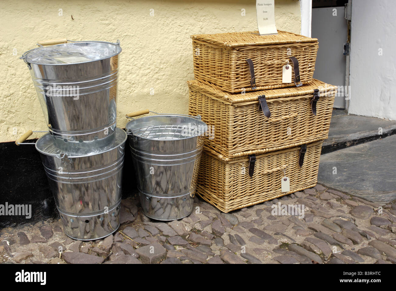 Traditional Wicker hamper baskets and stainless steel milking buckets Stock Photo