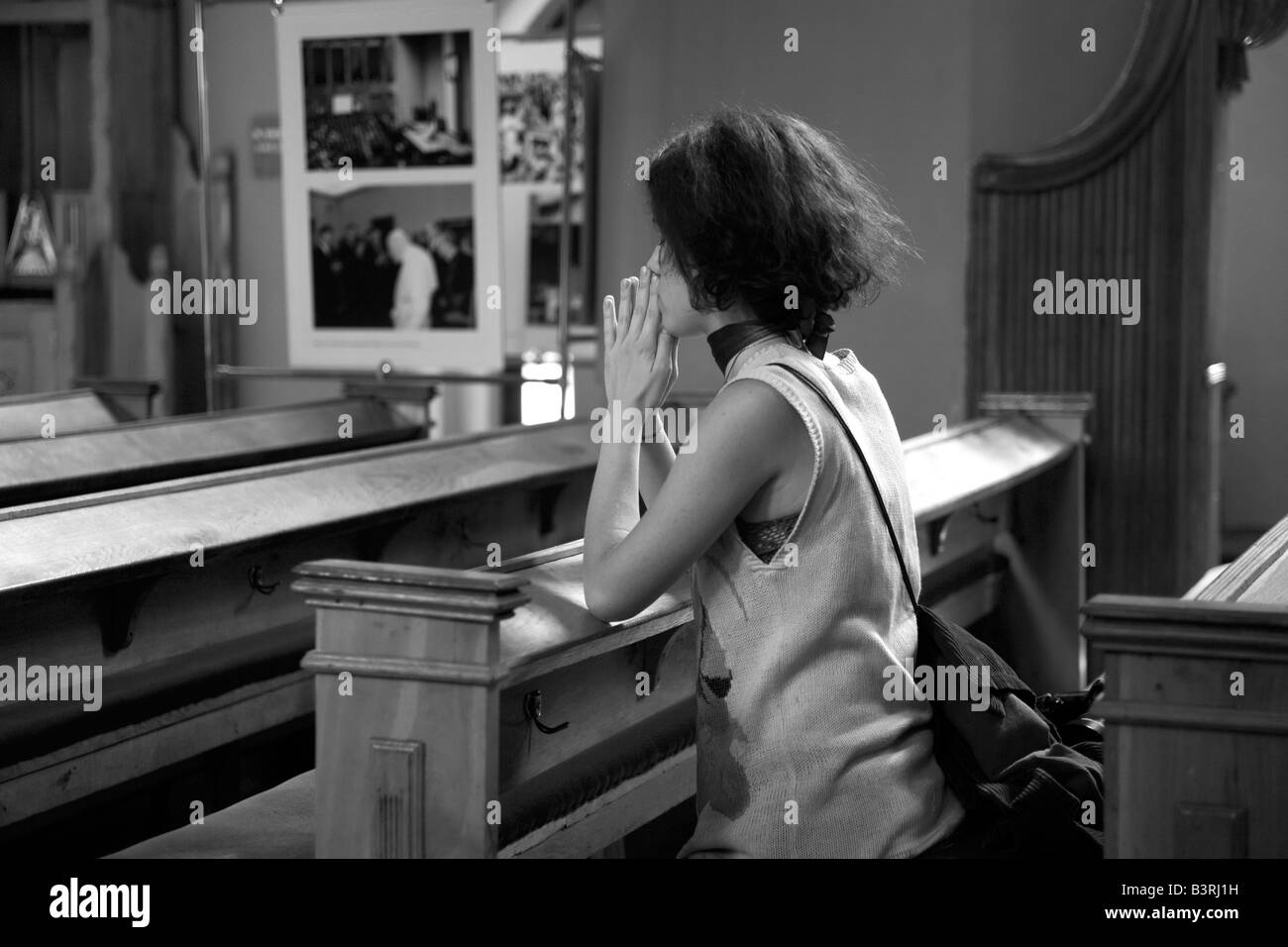 Young woman praying Catholic church Zielona Gora, Poland Stock Photo