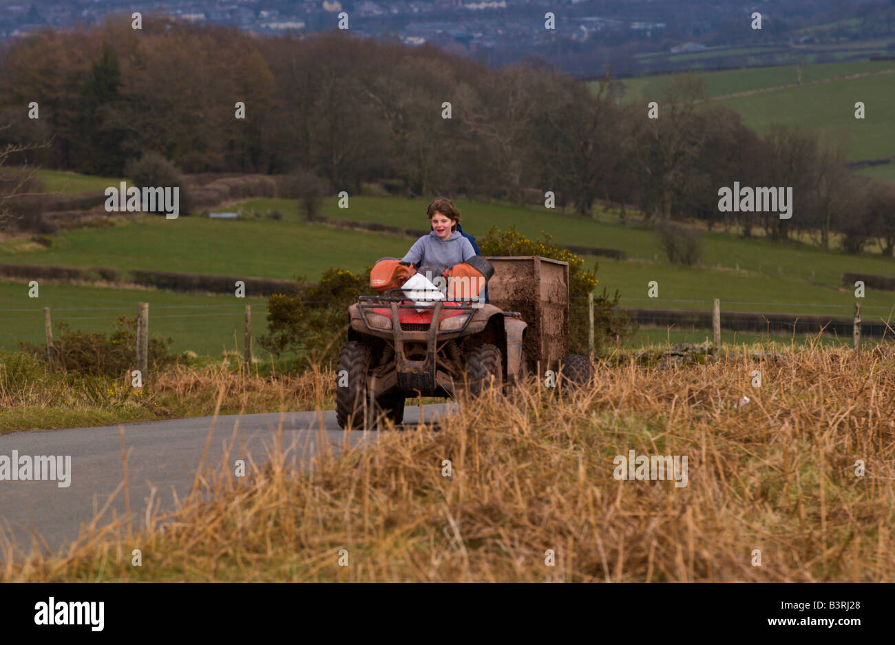 Two farm girls on quad bike with trailer on Mynydd Illtyd Common near