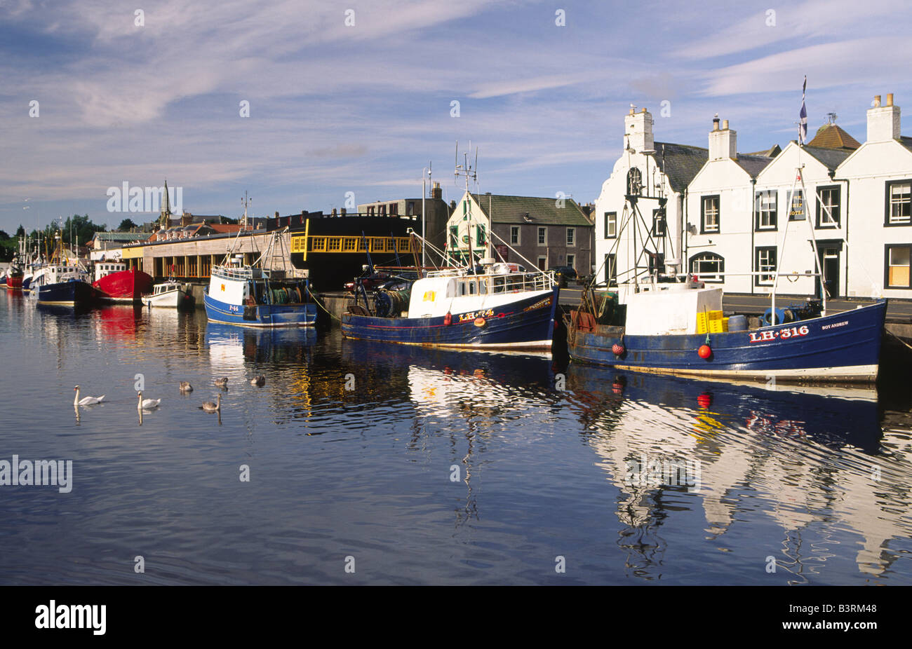 Fishing boats on a quiet still morning in a picturesque scenic Eyemouth ...