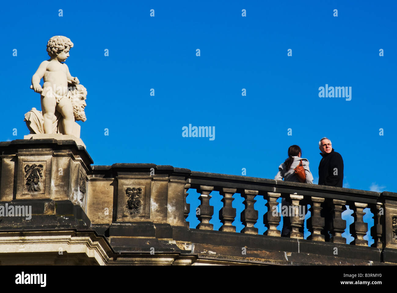 Tourists look over a balcony from the Zwinger, Dresden, Germany Stock Photo