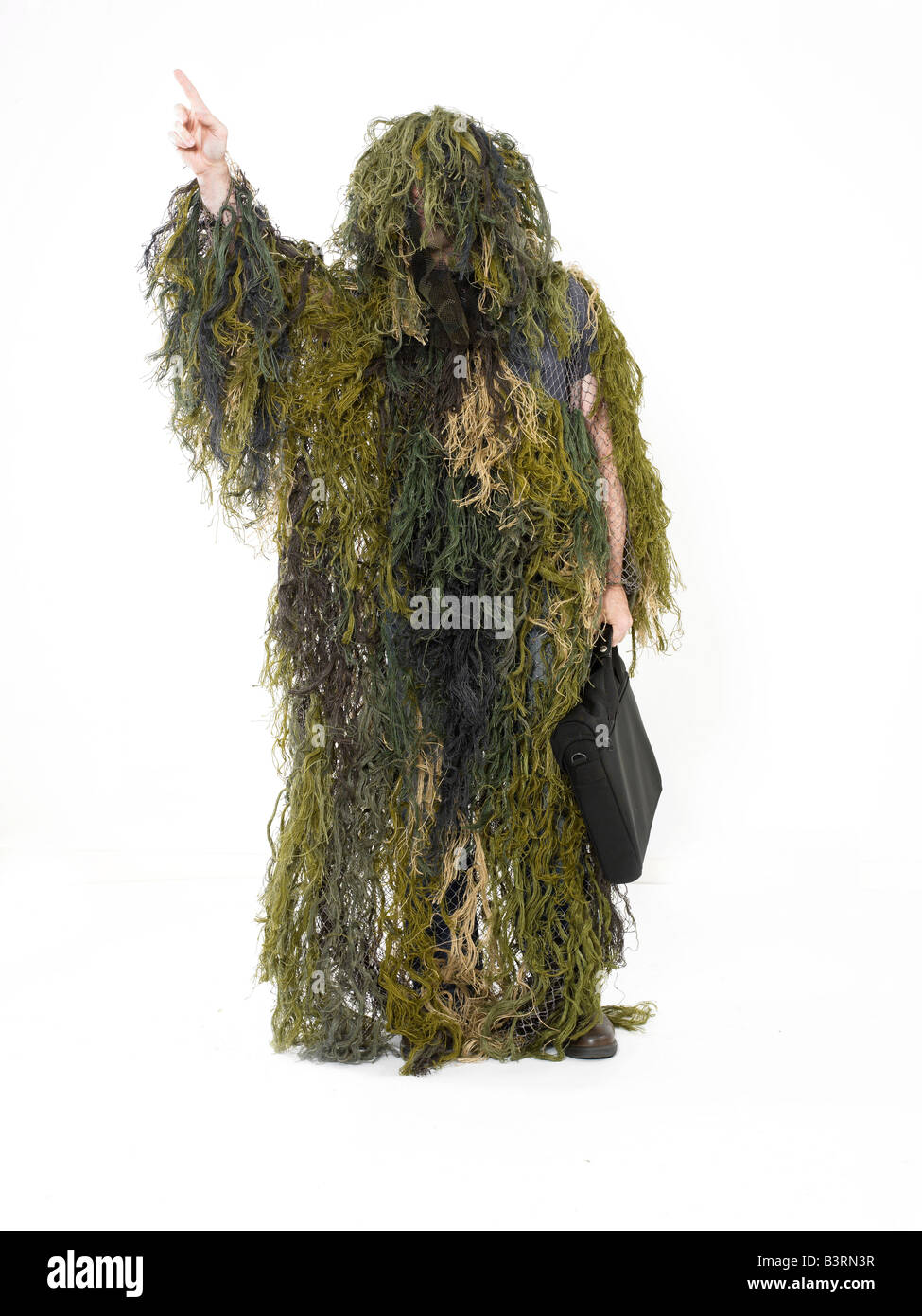 A man in a ghillie suit hailing a cab Stock Photo