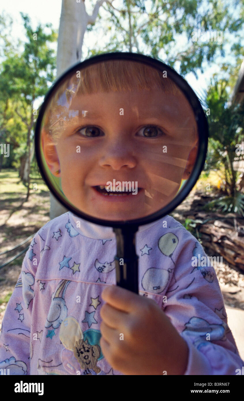 Young girl with magnifying ^glass Stock Photo Alamy
