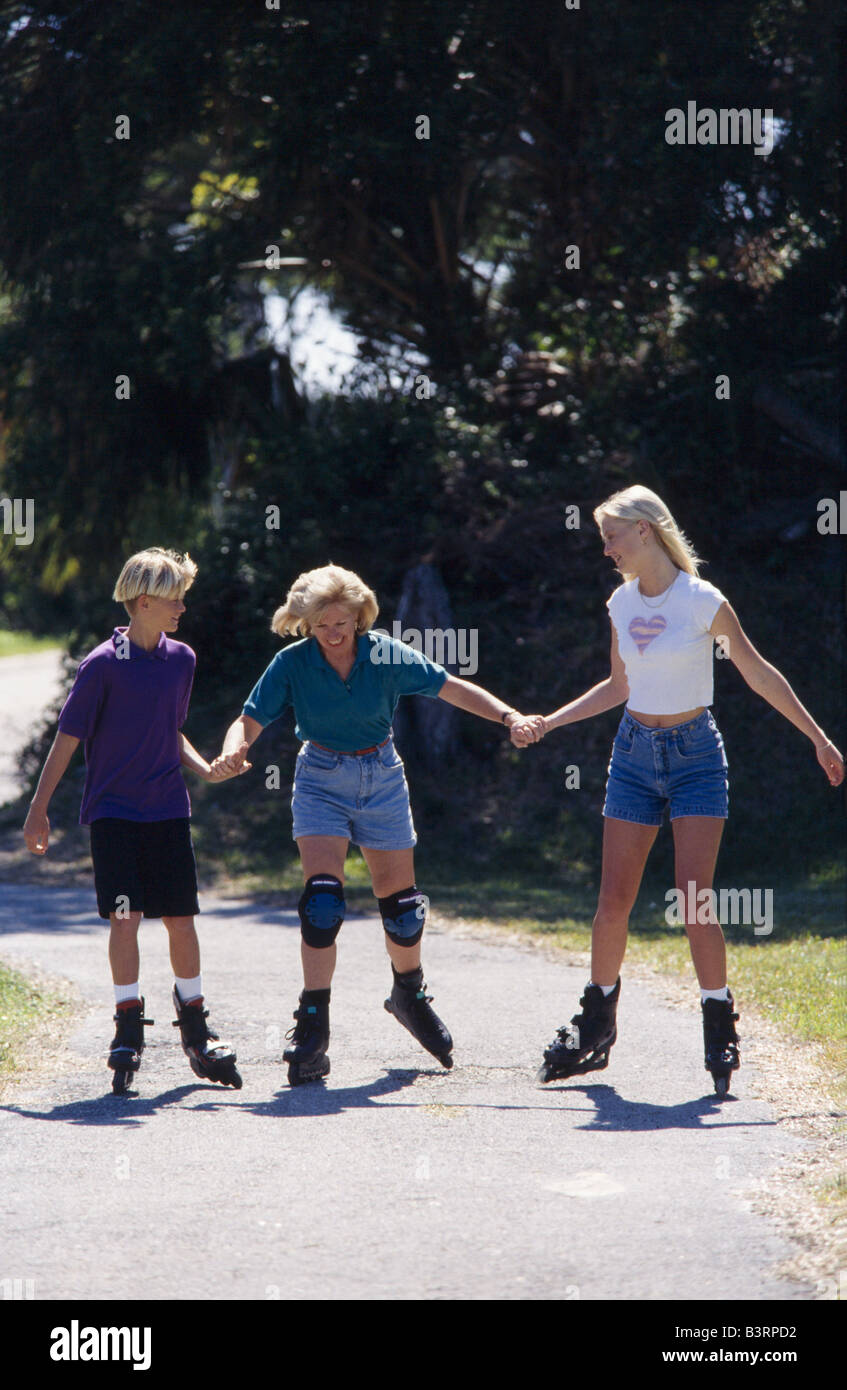 Grandmother and grandkids, rollerblading together in park, Miami. Stock Photo