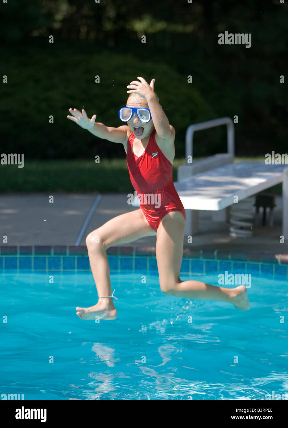 Child jumping into a backyard swimming pool Stock Photo - Alamy