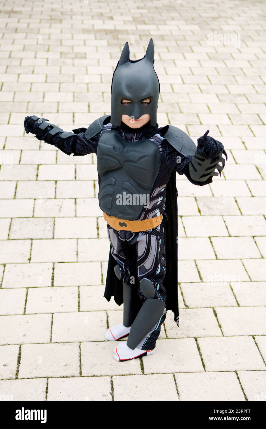 Portraits of young four year old boy dressed up in Batman suit posing in front of suburban house in Perth Western Australia Stock Photo